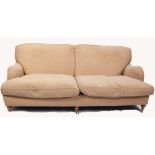 MODERN, FULLY UPHOLSTERED FOUR SEATER SETTEE with two loose cushions, on turned forelegs with