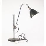 CHROME PLATED FRENCH ADJUSTABLE DESK OR TABLE LAMP, with black Jappanned shade and circular base,