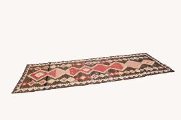 CAUCASIAN TRIBAL KELIM RUNNER, with eight diamond shaped pole medallions in red and white on a