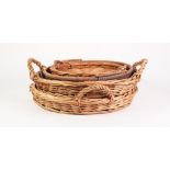 PAIR OF CIRCULAR TWO HANDLED WICKER BREAD TRAYS, 18 ½" (47cm) diameter, together with ANOTHER,