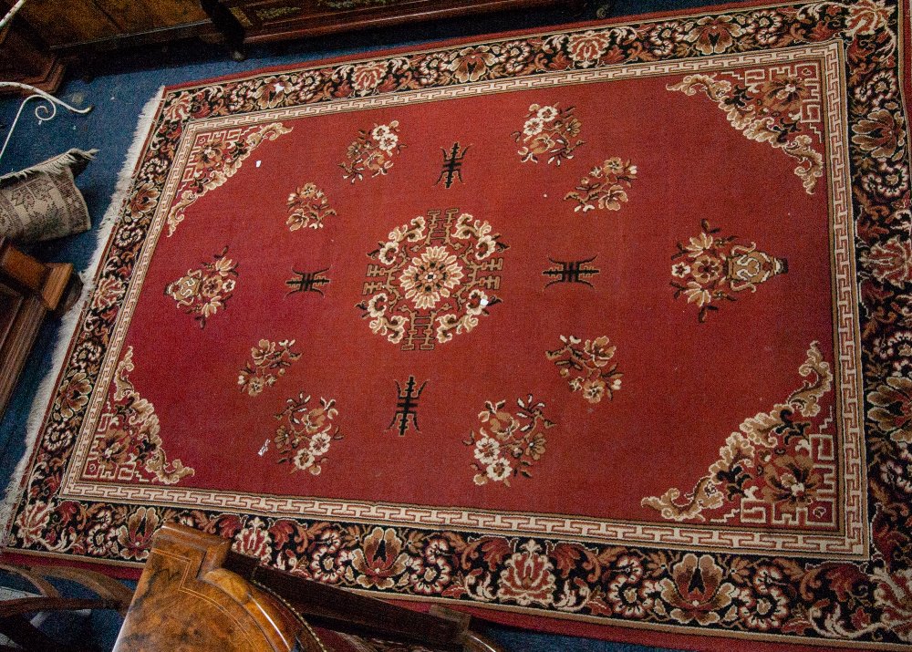 MACHINE MADE EASTERN CARPET, with floral centre medallion, scattered floral sprays and floral