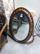 AN OVAL BEVELLED EDGE WALL MIRROR, IN CAVETTO FRAME AND ANOTHER OVAL WALL MIRROR, IN GILT FRAME (2)