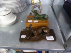 BRONZE CASED MODEL OF A GREYHOUND ON A RUG, SIGNED WITH INITIALS O.F.A., 7 3/4" long AND A GREEN