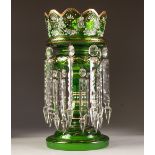 VICTORIAN GREEN TINTED GLASS TABLE LUSTRE, of typical form with angular wavy rim and prismatic