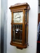 A WELLINGTON WALL CLOCK, WITH 8 DAYS STRIKING AND CHIMING MOVEMENT, WITH SILVERED ARABIC DIAL, IN