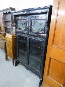 A LATE NINETEENTH CENTURY DARK OAK BOOKCASE, THE UPPER SECTION ENCLOSED BY TWO LEADED AND STAINED