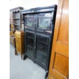 A LATE NINETEENTH CENTURY DARK OAK BOOKCASE, THE UPPER SECTION ENCLOSED BY TWO LEADED AND STAINED