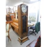 A 1930's ENFIELD LONGCASE CLOCK, WITH 8 DAYS WEIGHT DRIVEN MOVEMENT, CIRCULAR SILVERED DIAL, THE