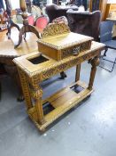 A 20TH CENTURY OAK HALL STAND WITH RAISED CENTRAL DRAWER HAVING LION HANDLE, UMBRELLA STANDS TO