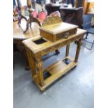 A 20TH CENTURY OAK HALL STAND WITH RAISED CENTRAL DRAWER HAVING LION HANDLE, UMBRELLA STANDS TO