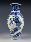 CHINESE PORCELAIN BLUE AND WHITE OVULAR VASE, with waisted neck, embossed with white dragons on a