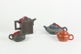 FOUR CHINESE YIXING STONE CHINA TEAPOTS, in varying colour clays, also an INDIAN CARVED IVORY