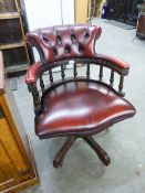 A REPRODUCTION CAPTAIN'S CHAIR, WITH RED HIDE UPHOLSTERY, ON OUTSWEPT SUPPORTS