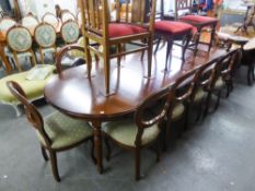 A GOOD QUALITY MAHOGANY REPRODUCTION DINING TABLE WITH TWO EXTRA LEAVES AND A SET OF TEN DINING