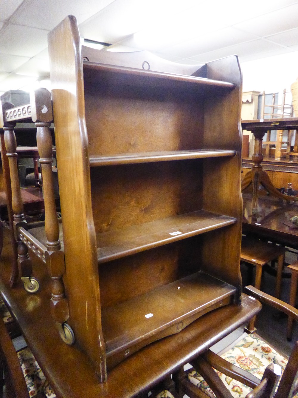 AN OAK TWO TIER DINNER WAGON WITH CARVED GALLERY BORDERS AND A SMALL OAK FOUR TIER OPEN BOOKCASE, 2'