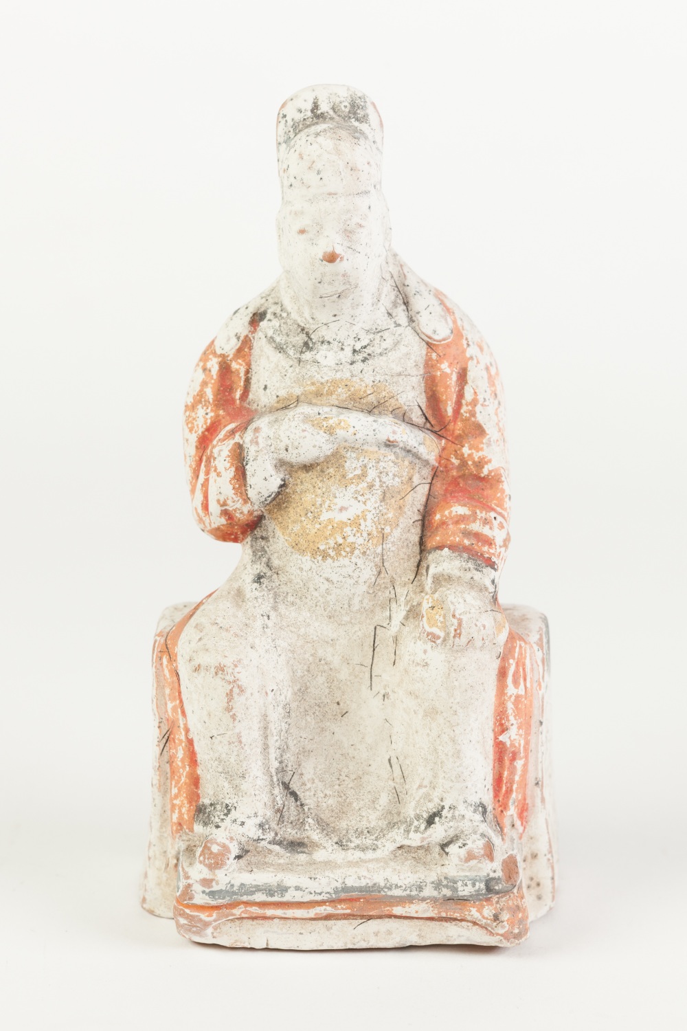 AN AGED CHINESE WHITE CHALK SURFACED TERRACOTTA BISCUIT FIGURE of an enthroned dignitary with in