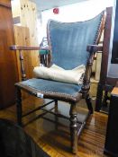 A SMALL HARDWOOD, EARLY 20TH CENTURY NURSING ARMCHAIR WITH UPHOLSTERED BACK AND SEAT COVERED IN