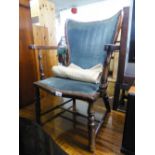 A SMALL HARDWOOD, EARLY 20TH CENTURY NURSING ARMCHAIR WITH UPHOLSTERED BACK AND SEAT COVERED IN