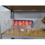 A QUANTITY OF CUT GLASS DRINKING GLASSES, SOME WITH ETCHED DETAIL