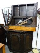 A JUST PRE-WAR OR POST-WAR WARING AND GILLOW CARVED OAK DRINKS BAR AND THREE BAR STOOLS