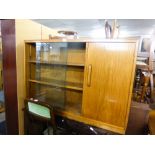 A WALNUTWOOD SMALL BOOKCASE WITH GLASS SLIDING DOORS AND END CUPBOARD