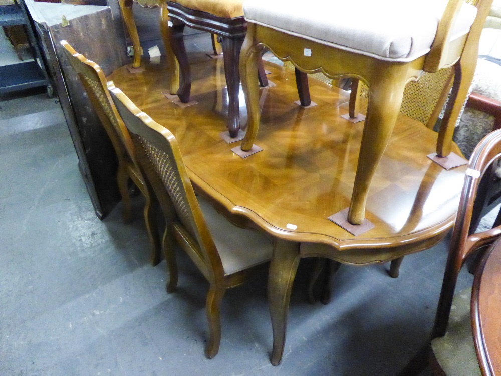 A CONTINENTAL CARVED WALNUTWOOD DINING ROOM SUITE COMPRISING; SIX DINING CHAIRS, WITH CANE PANEL