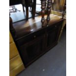 A DARK WOOD SMALL CABINET WITH TWO DRAWERS OVER TWO CUPBOARD DOORS