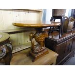 A MAHOGANY OVAL LOW OCCASIONAL TABLE, on carved wood bird and snake support and an oblong base