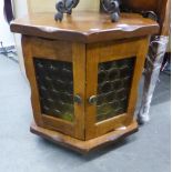 A TEAK WOOD HEXAGONAL LOW OCCASIONAL TABLE OR SMALL CUPBOARD WITH TWO GLAZED DOORS