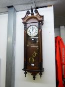 A WALNUTWOOD CASED VIENNA WALL CLOCK WITH SPRING DRIVEN MOVEMENT