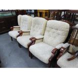 A SET OF THREE ERCOL STYLE ELM FIRESIDE ARMCHAIRS, UPHOLSTERED AND COVERED IN LEAF SCROLL EMBOSSED