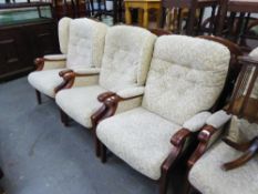 A SET OF THREE ERCOL STYLE ELM FIRESIDE ARMCHAIRS, UPHOLSTERED AND COVERED IN LEAF SCROLL EMBOSSED