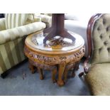 A MODERN CHINESE HARDWOOD NEST OF CIRCULAR TABLES CARVED IN HIGH RELIEF; THE TOP DEPICTING FIGURES