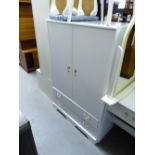 A SMALL WHITE FINISH BEDROOM SUITE COMPRISING; A LOW HANG WARDROBE WITH TWO LONG DRAWERS BELOW; A