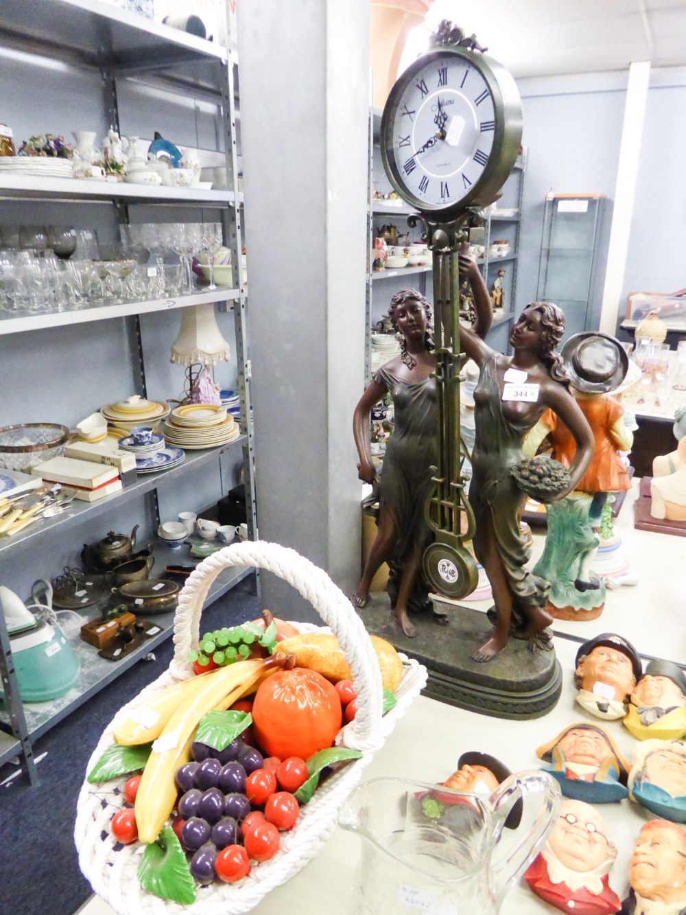 MODERN JULIANA FLOOR CLOCK OF TWO CLASSICAL MAIDENS HOLDING THE SWINGING CLOCK ALOFT, ALL RAISED