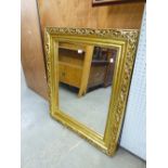 AN OBLONG WALL MIRROR, IN GILT FRAME