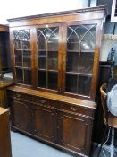 A REPRODUCTION BOOKCASE, GLAZED UPPER PORTION WITH DRAWERS AND CUPBOARDS UNDER