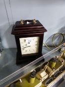 A MAHOGANY BRACKET CLOCK WITH BRASS CARRYING HANDLE WITH QUARTZ MOVEMENT