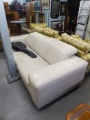 A CREAM HIDE THREE SEATER SETTEE