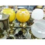 NEAR PAIR OF VICTORIAN BRASS OIL LAMPS, EACH WITH YELLOW GLOBE SHADES, ONE WITH GLASS FUNNEL, THE