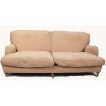 MODERN, FULLY UPHOLSTERED FOUR SEATER SETTEE with two loose cushions, on turned forelegs with