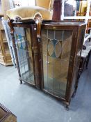 A LEADED GLASS TWO DOOR DISPLAY CABINET WITH CHINOISERIE DECORATION