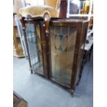 A LEADED GLASS TWO DOOR DISPLAY CABINET WITH CHINOISERIE DECORATION