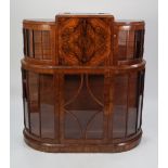 a 1930's WALNUT WRITING AND DISPLAY CABINET, centred with a fall front writing compartment above a