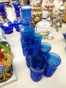 A MID TWENTIETH CENTURY BLUE CUT GLASS DECANTER WITH SIX TUMBLERS