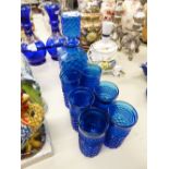 A MID TWENTIETH CENTURY BLUE CUT GLASS DECANTER WITH SIX TUMBLERS