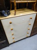 A MODERN LIGHT OAK AND REAM FRONTED CHEST OF FOUR LONG DRAWERS