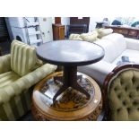 A LOW CIRCULAR TOP BAKELITE COFFEE TABLE