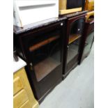 A PAIR OF MAHOGANY SMALL CABINETS, EACH ENCLOSED BY A GLAZED DOOR