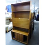 A TEAK NARROW WALL UNIT WITH DROP-FRONT SECTION TO THE TOP AND SLIDING DOORS BELOW